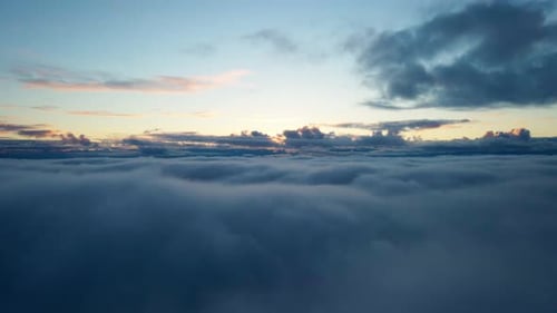 Aerial View Above Fluffy Clouds at Sunrise
