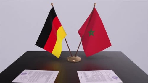 Germany and Morocco Flags Stand on Desk