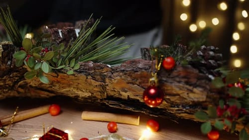 Christmas day in the workshop, a girl glues berries and toys on pine bark. Creating a beautiful home