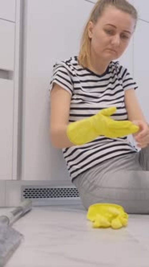 A Tired Housewife Resting for a Few Minutes After a Long Day of Cleaning the Apartment