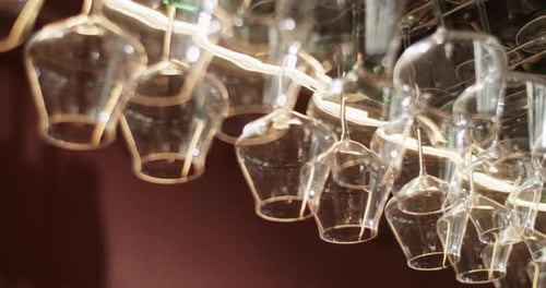Wine Glasses Hanging on Rack in Bar