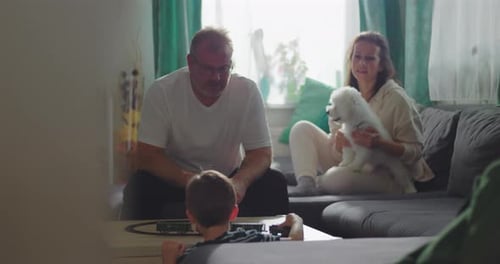 Family Plays with Toy Train Set at Home