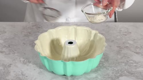 Bundt-Kuchenform mit Gemüsefett und Mehl einfetten, um den Funfettti-Bundt-Kuchen zu backen