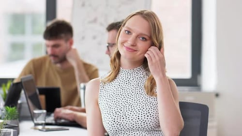 Smiling Woman Working with Colleagues in Office