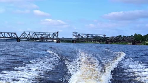 Trail on water surface behind of fast moving motor boat