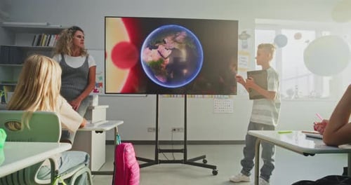 Primary School Boy Showcasing Knowledge of Astronomy in Front of Class and Teacher Using Digital