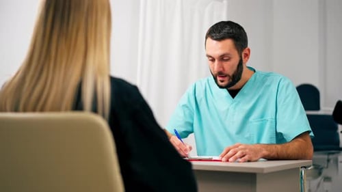 Doctor Consulting with Patient in Clinical Setting