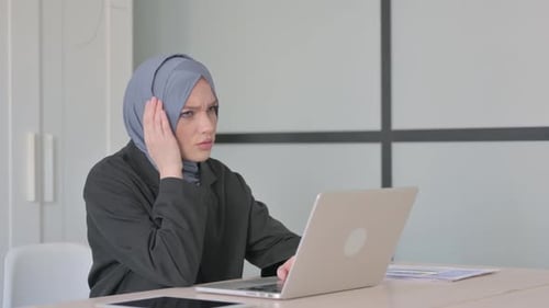 Woman in Hijab Working, Feeling Stressed