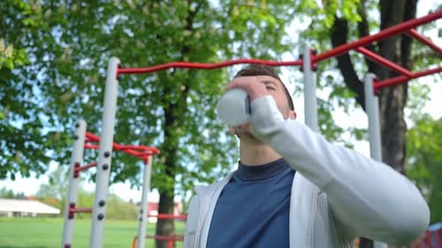 Man Drinks Water After Outdoor Workout