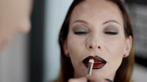 Closeup View of Female Face During Work of Professional Makeup Artist Middleaged Lady Model