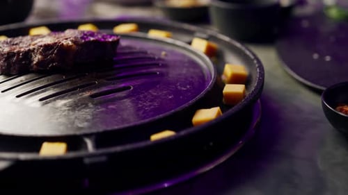 close up of delicious appetizing juicy piece of grilled meat with cheese being fried in restaurant