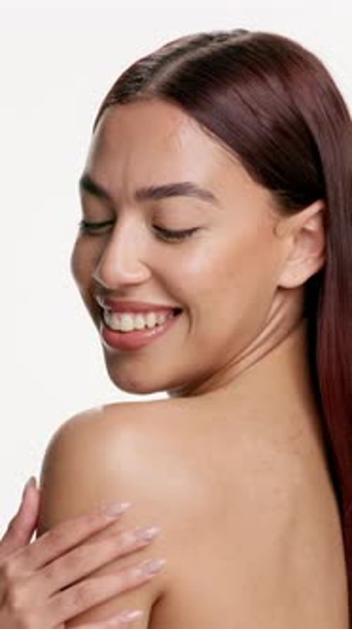 Skincare, face and shoulder touch with woman for smile, wellness and glow for self care in studio