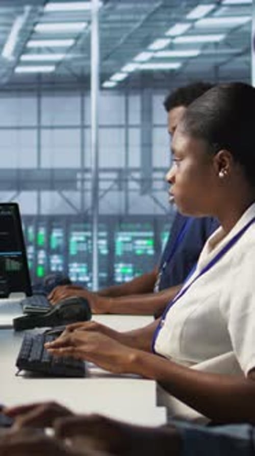 Vertical Video Cybersecurity Experts in Server Farm Trying to Protect Equipment From Hacker