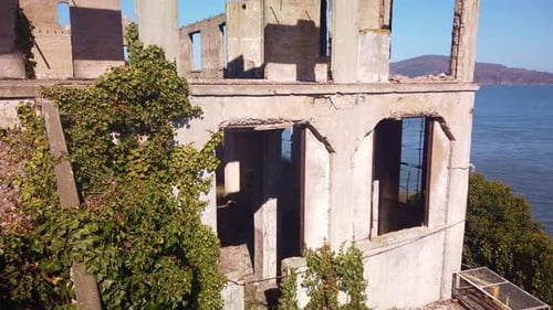 Gimbal tilting up shot of the ruins of the Guard House on Alcatraz Island in the San Francisco Bay.