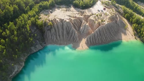 Aerial Footage of Bluish Pond Surrounded with High Sandy Cliffs