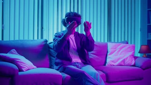 Young Adult Using VR Headset on Couch