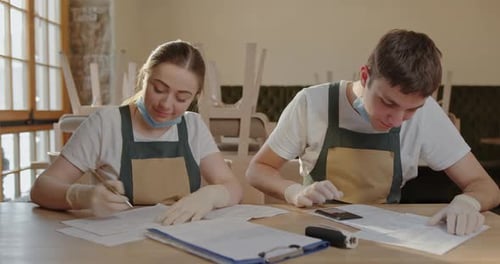 Cafeteria Owners Analyzing Financial Records