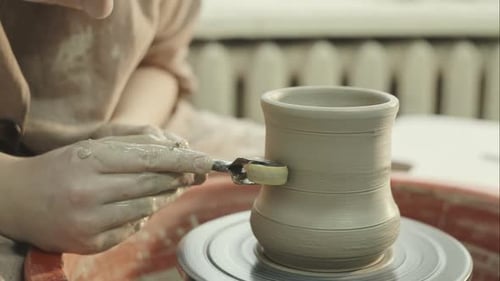 The Young Potter Puts Pattern on Clay Vase
