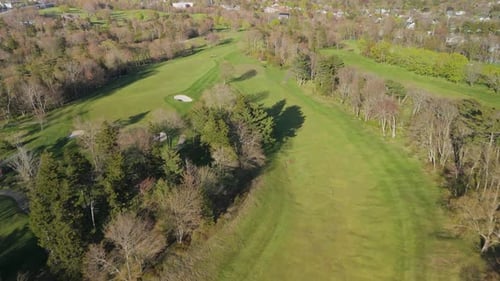 Aerial Footage Of Golf Course Players And Groundskeepers Working Together