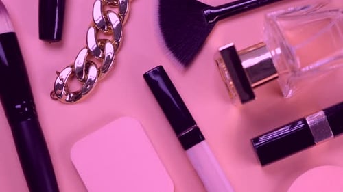 Rotating Background with Decorative Cosmetics and Bijouterie Chain Bracelet and Earrings or Clips or