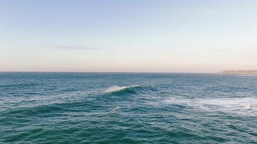 Small wave forming with distant coastline