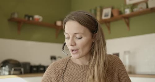 Woman in headset talking during a video conference