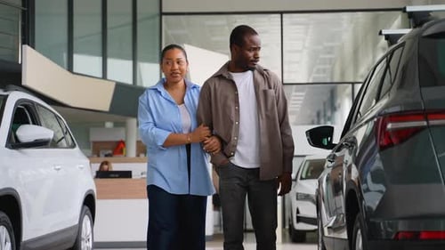 Young Couple Shopping for Cars at Dealership