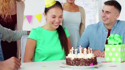 Celebrating Woman's Birthday with Cake and Coworkers