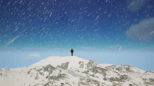 Person Standing On Top Of A Snow Covered Mountain. Cold Snowy Landscape Aerial