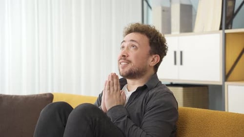 Happy young man praying.