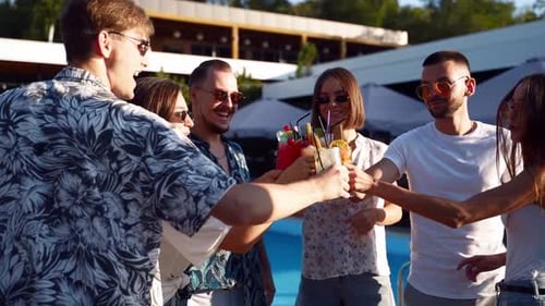 Friends Toasting Cocktails at Summer Poolside Party
