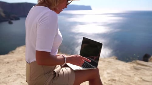 Digital Nomad Business Woman Working on Laptop By the Sea