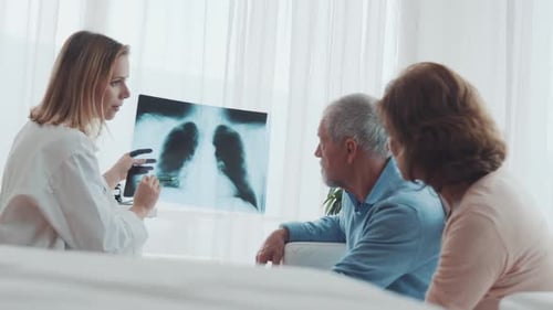 Female Doctor Talking to a Senior Couple in Office