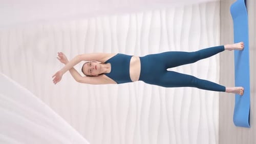 Woman Does Yoga Stretching Exercises at Home