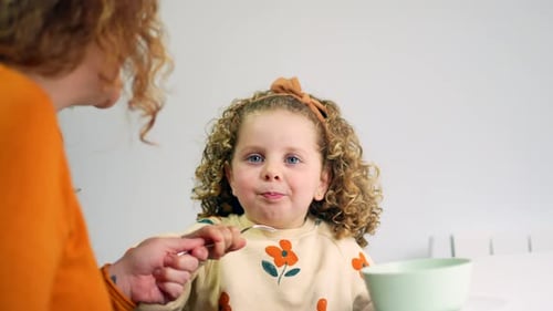 Little Girl Eats Food Fed By Adult