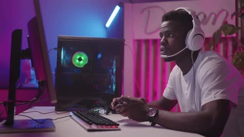 Young Adult Gamer Playing with Controller at Home