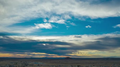 Colorful and dynamic cloudscape over the arid terrain of the Mojave Desert - static time lapse