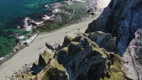 Marvel at Aerial Footage of Ocean Cliff and Beach Showcasing Natures Beauty