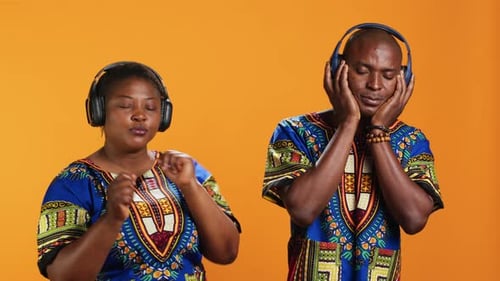 Smiling Couple Listening to Music and Dancing Together