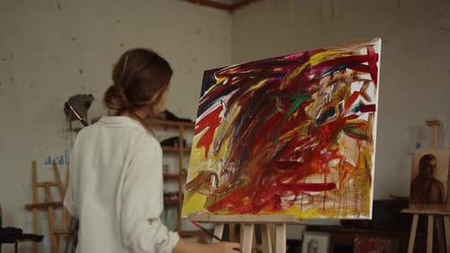 Contemporary Woman Painter Using Easel at Workplace. Back View of Talented Girl