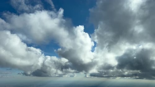 Clouds Drifting Across Sunny Blue Sky, Aerial View