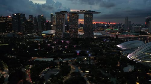 Aerial footage of the Gardens By The Bay and Marina Bay Sands Tower in Singapore.