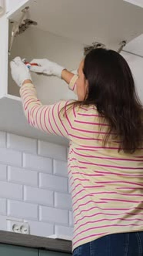 Female Renovating By Assembling Kitchen Set