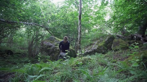 Hiker Putting Down His Backpack And Remove His Sweatshirt In Dense Forest. Static