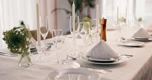 Elegant Table Setting with Candles and Floral Arrangement