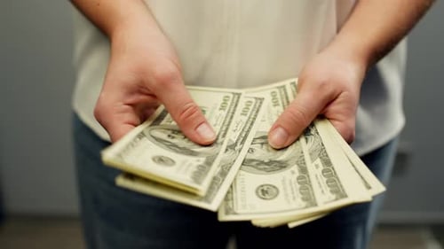 Woman Counts Stack of One Hundred Dollar Bills