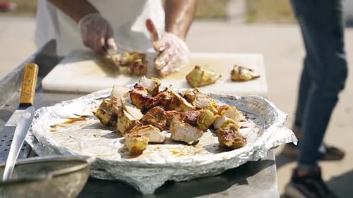 Slicing Cooked Chicken on a Platter
