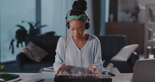 Young African American Woman Playing on Electronic Piano Synthesizer Keyboard Enjoying Sound