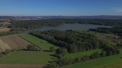 Lake in the middle of the fields. with lush greens.