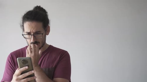 Adult Man Looking Worried While On Phone